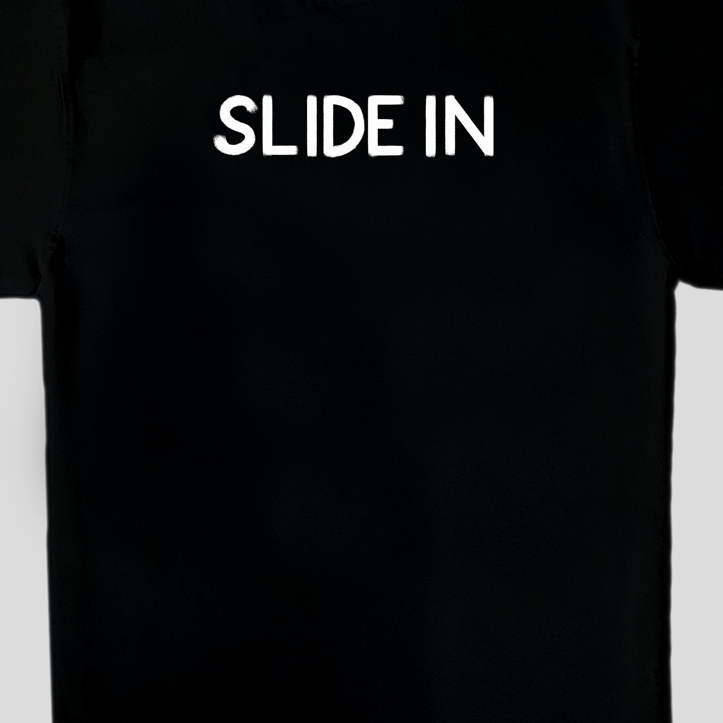 Black oversized t-shirt with graphic slidein in white, front view close up